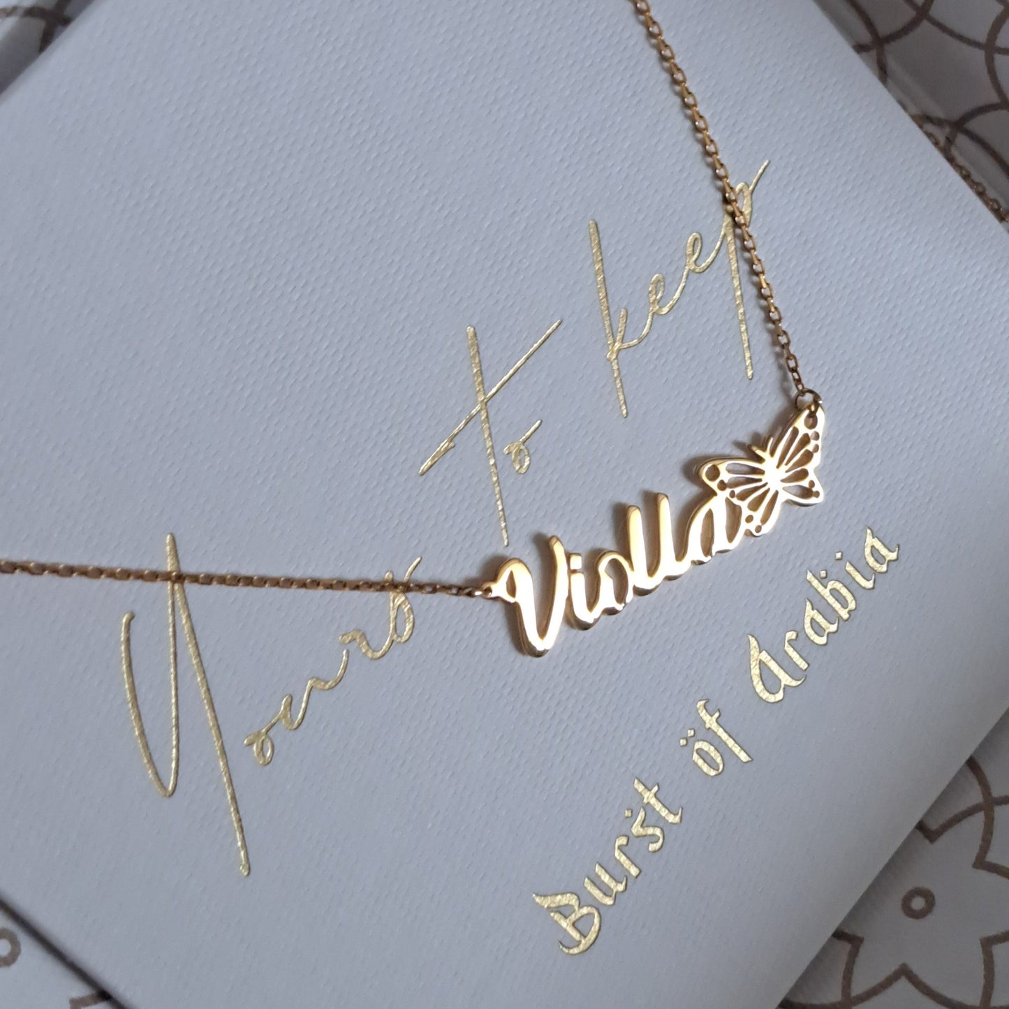 Personalized 18k butterfly name gold necklace available in yellow, white, and rose gold. Handcrafted in the UAE.