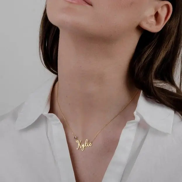 Simple yet eye-catching, this gold Alphabet gold name necklace with birthstone is a stylish look anyone will appreciate. Whether you’re treating yourself or hunting for a unique, priceless and luxurious anniversary or birthday gift, our gold jewelry collections allow you to wonderfully express what's in your heart. Handcrafted in Dubai, United Arab Emirates.