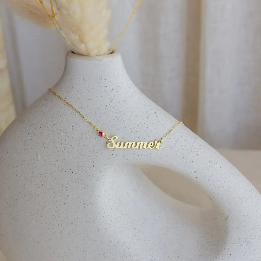 Simple yet eye-catching, this gold Alphabet gold name necklace with birthstone is a stylish look anyone will appreciate. Whether you’re treating yourself or hunting for a unique, priceless and luxurious anniversary or birthday gift, our gold jewelry collections allow you to wonderfully express what's in your heart. Handcrafted in Dubai, United Arab Emirates.