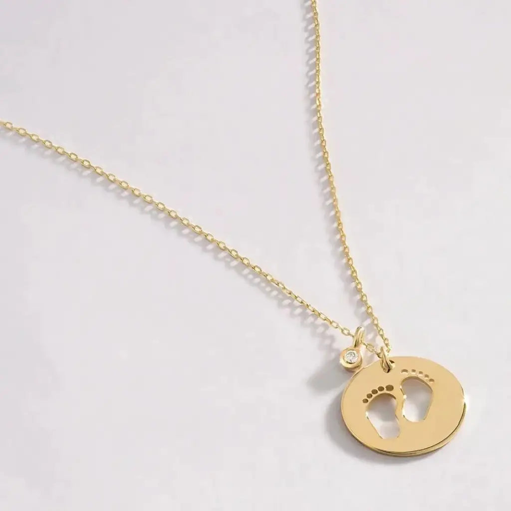 18K Gold Baby Feet Birthstone Necklace Designed and handcrafted in the UAE.