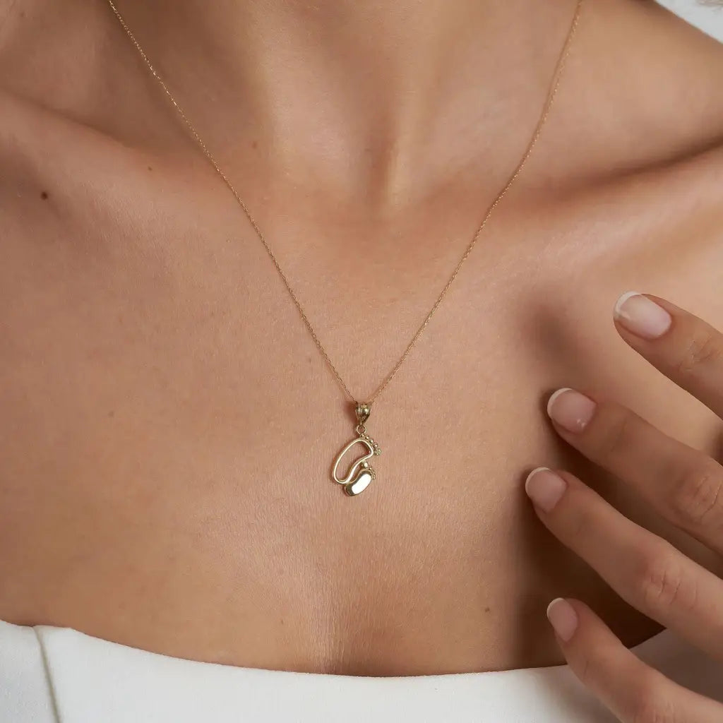 18K Gold Personalized Baby Feet Necklace Designed and handcrafted in the UAE.