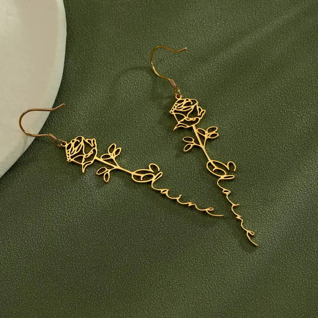 Birth flower name earrings made in real gold. Designed and handcrafted in the UAE. These gorgeous elegant birth flower name earrings are locally handcrafted with the highest quality materials and artisans available in Dubai.