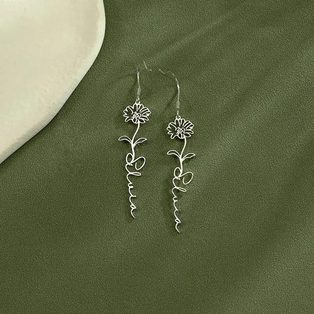 Birth flower name earrings made in real gold. Designed and handcrafted in the UAE. These gorgeous elegant birth flower name earrings are locally handcrafted with the highest quality materials and artisans available in Dubai.