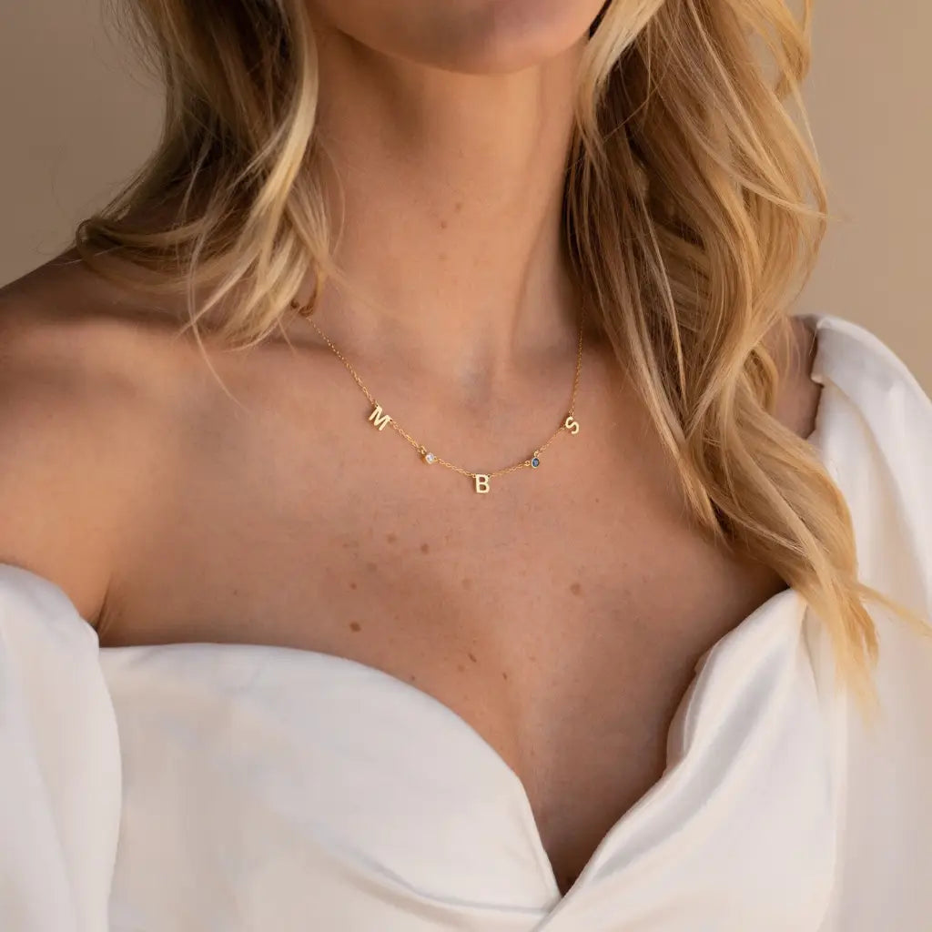 Our distinctive Birthstone Name Necklace is ethically crafted in real genuine gold by our skilled jewelers in Dubai. A truly lovely gift. Your loved one's name in gold, enhanced with their birthstone, creating a uniquely, personal gift. Gift a memory keeper for life. Designed in the United Arab Emirates.