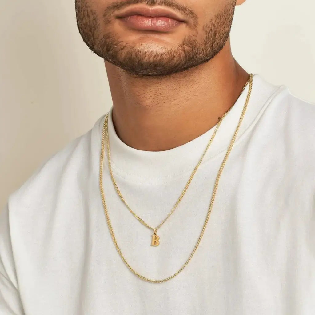 Trendy and elegant, this stunning gold alphabet pendant has a playful charm. Attached to a box chain made of genuine solid gold and personalized with the initial of your choice. A thoughtful luxury anniversary gift for your boyfriend or husband, and the perfect expensive birthday gift for a father or a brother.