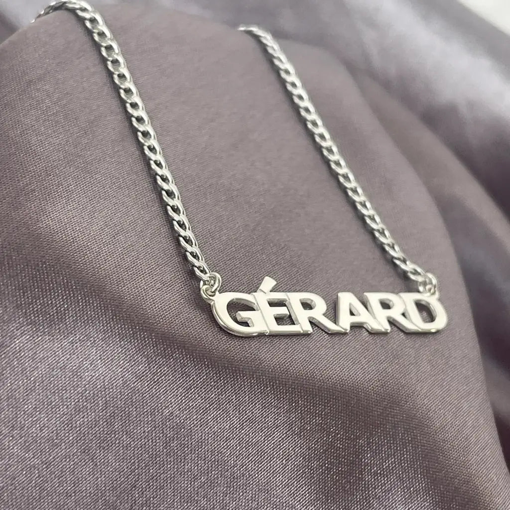 Luxury Gold Custom Name Necklace for men made of genuine 18k solid gold and personalized with the words of your choice. A thoughtful luxury anniversary gift for your boyfriend or husband, and the perfect expensive birthday gift for a father or a brother.