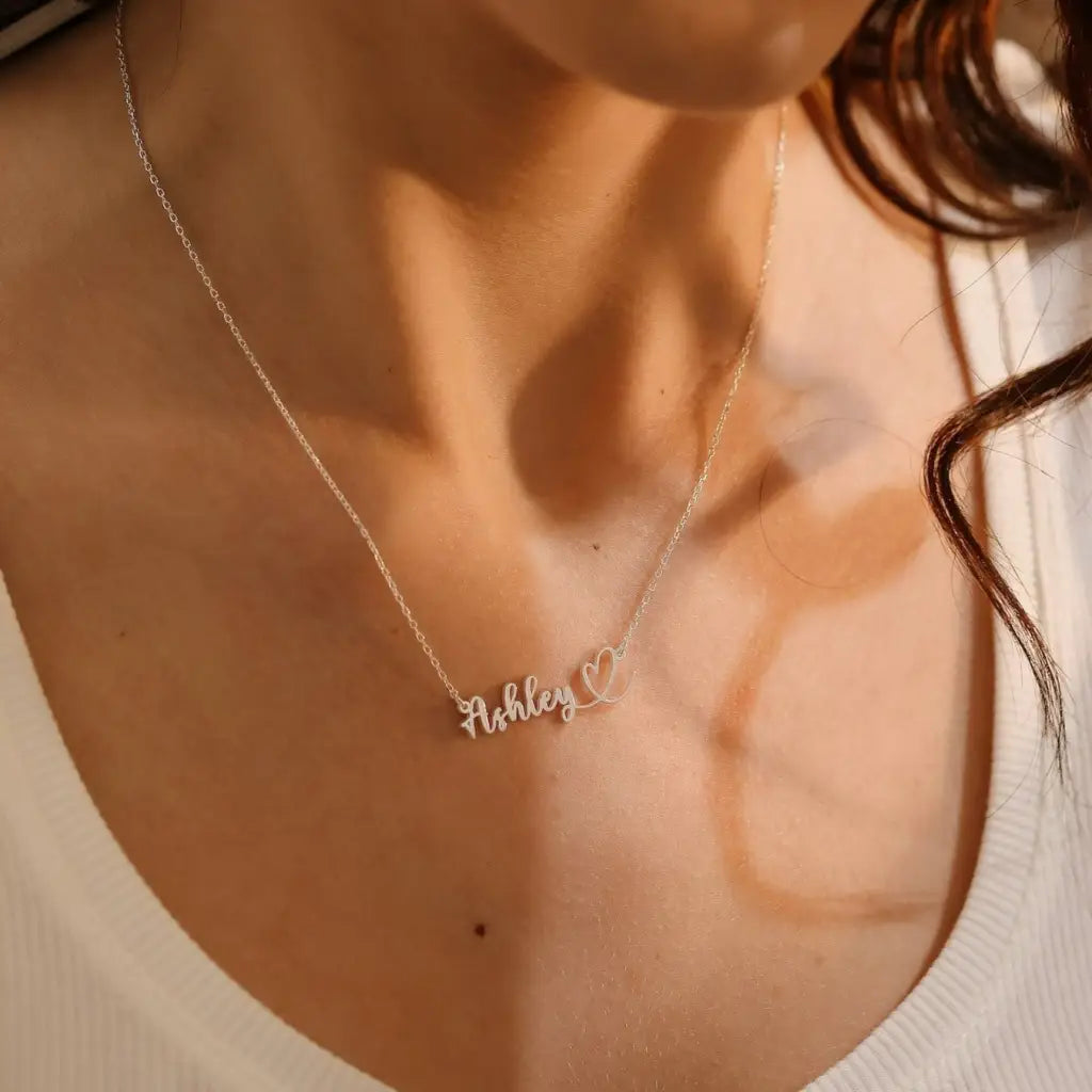This gold heart name necklace is a stylish look anyone will appreciate. Whether you’re treating yourself or hunting for a unique, priceless and luxurious anniversary or birthday gift, our gold jewelry collections allow you to wonderfully express what's in your heart. Handcrafted in Dubai, United Arab Emirates.