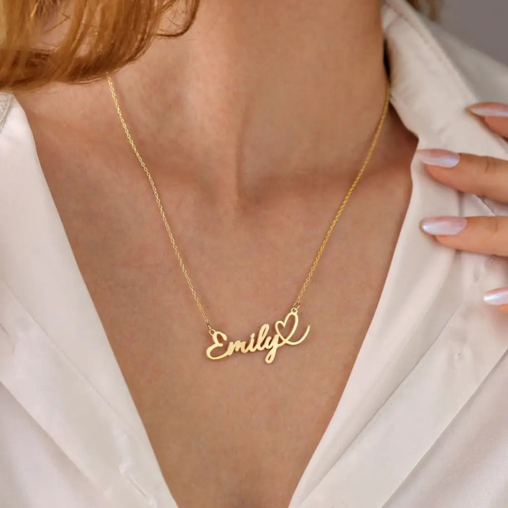 This gold heart name necklace is a stylish look anyone will appreciate. Whether you’re treating yourself or hunting for a unique, priceless and luxurious anniversary or birthday gift, our gold jewelry collections allow you to wonderfully express what's in your heart. Handcrafted in Dubai, United Arab Emirates.