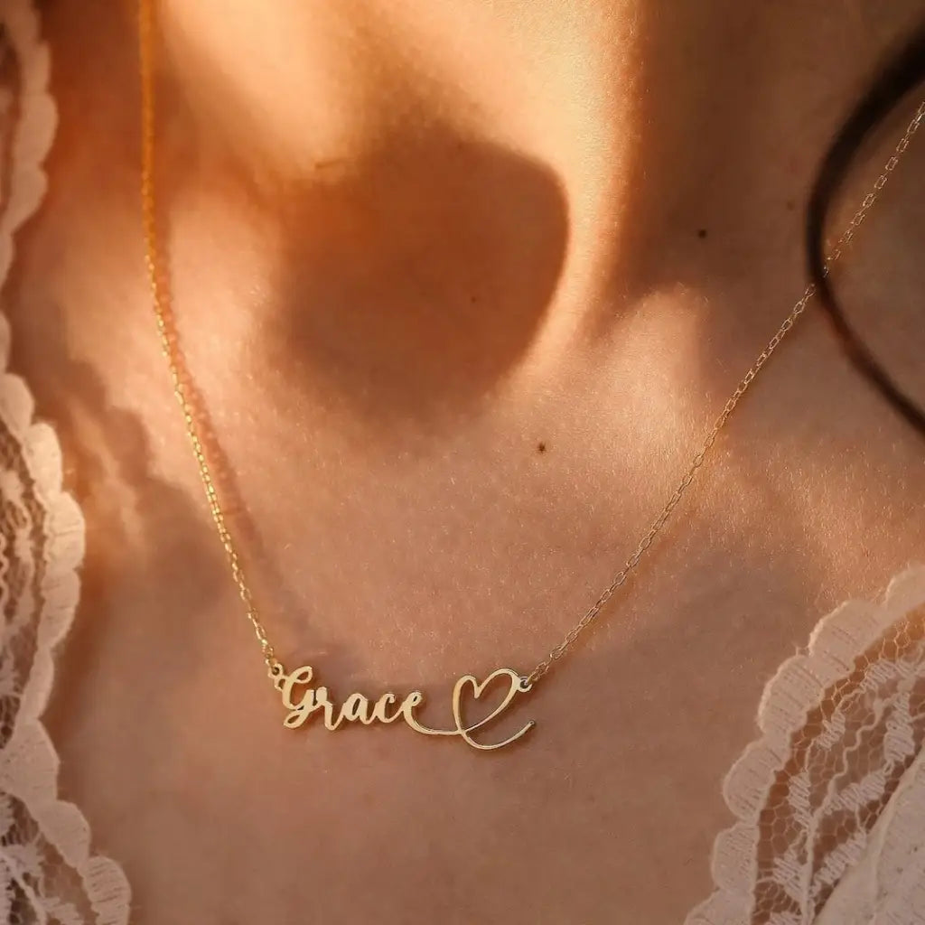 This gold heart name necklace is a stylish look anyone will appreciate. Whether you’re treating yourself or hunting for a unique, priceless and luxurious anniversary or birthday gift, our gold jewelry collections allow you to wonderfully express what's in your heart. Handcrafted in Dubai, United Arab Emirates.