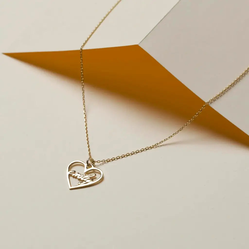 18k Gold Heart-shaped Necklace. Made in genuine gold, this heart-shaped name necklace will add a touch of luxury to any outfit whether you're treating yourself or looking for a meaningful gift for that special someone.