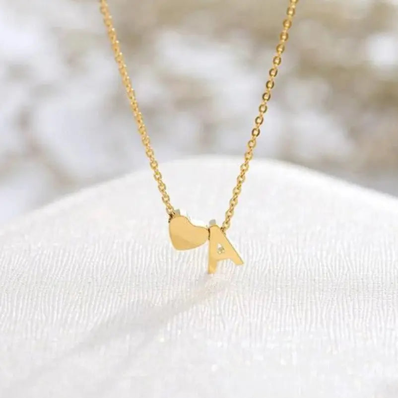 Gold Heart Letter Initial Necklace Personalized, designed and handcrafted in the UAE. Delivers within 2 to 5 business days.  This fine and minimal sideways initial necklace is locally handcrafted with the highest quality materials and artisans available in Dubai.