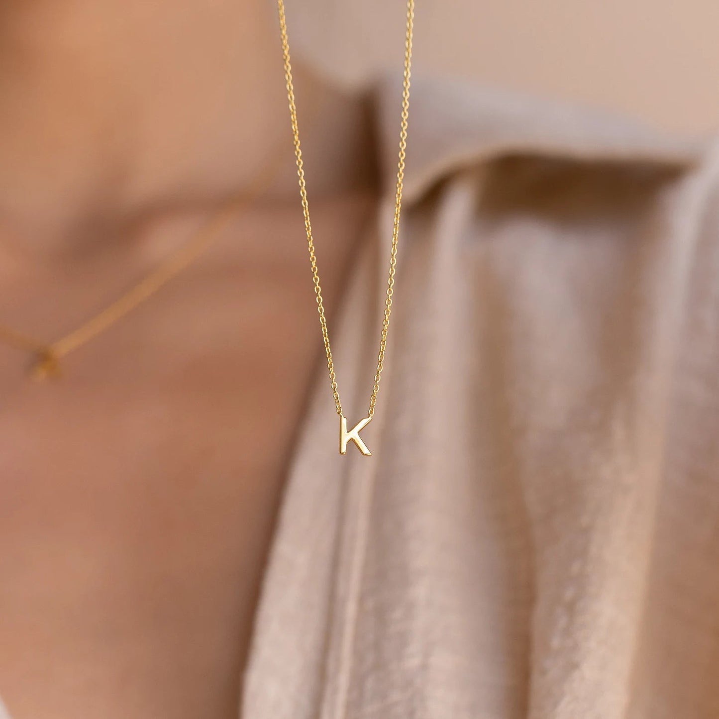 Gold initial necklace featuring exquisite craftsmanship, perfect for adding a touch of personalized elegance to your style.