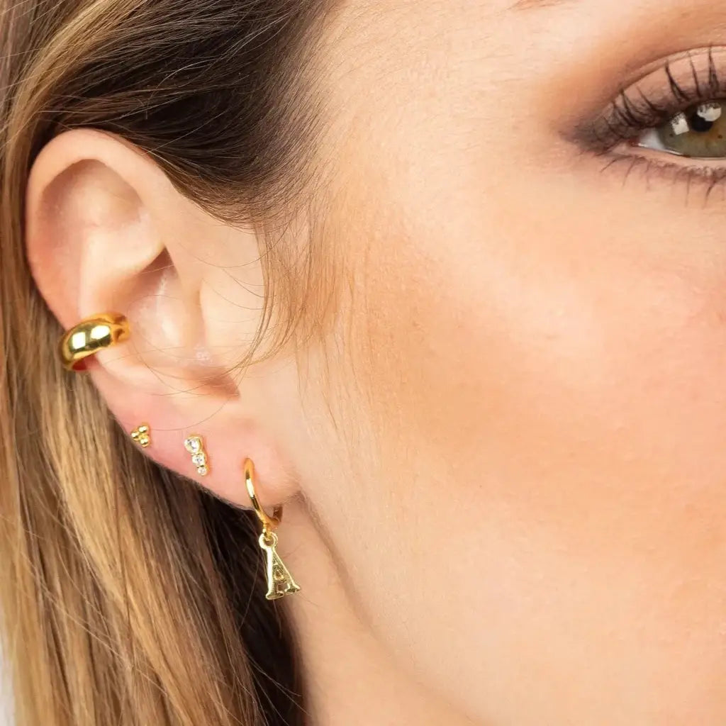 Personalized Initial Letter Hoop Earrings. Designed and handcrafted in the UAE. These gold alphabet initial earrings are locally handcrafted with the highest quality materials and artisans available in Dubai.