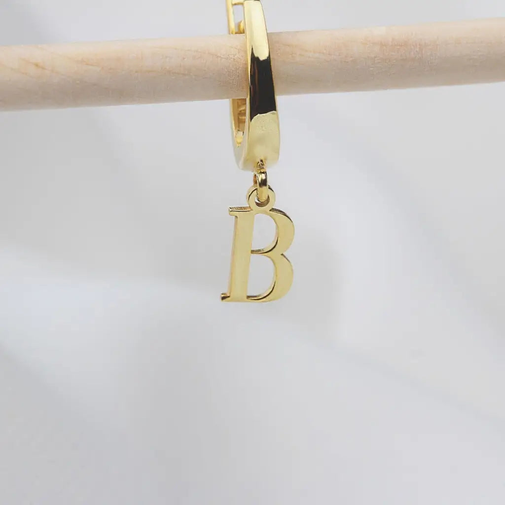 Personalized Initial Letter Hoop Earrings. Designed and handcrafted in the UAE. These gold alphabet initial earrings are locally handcrafted with the highest quality materials and artisans available in Dubai.