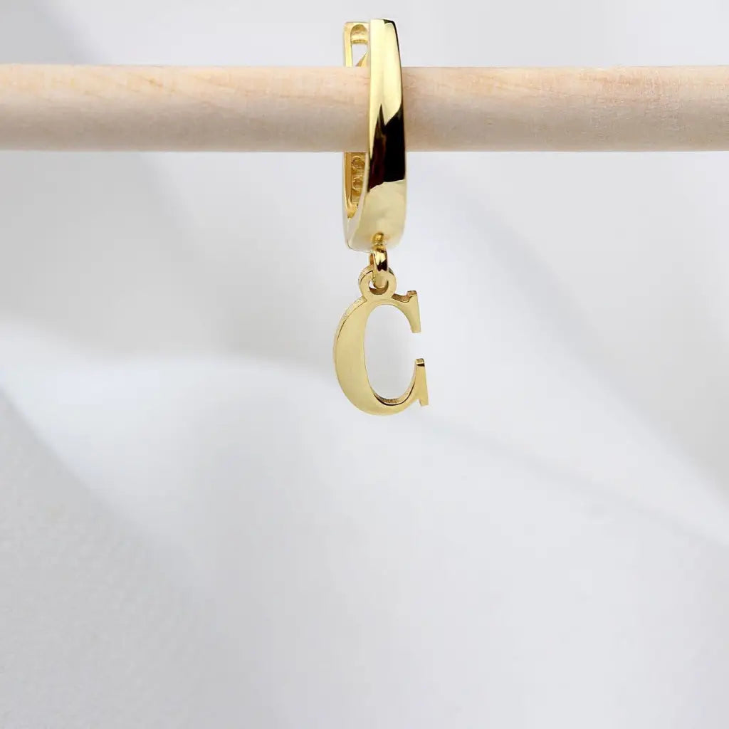Personalized Initial Letter Hoop Earrings. Designed and handcrafted in the UAE. These gold alphabet initial earrings are locally handcrafted with the highest quality materials and artisans available in Dubai.