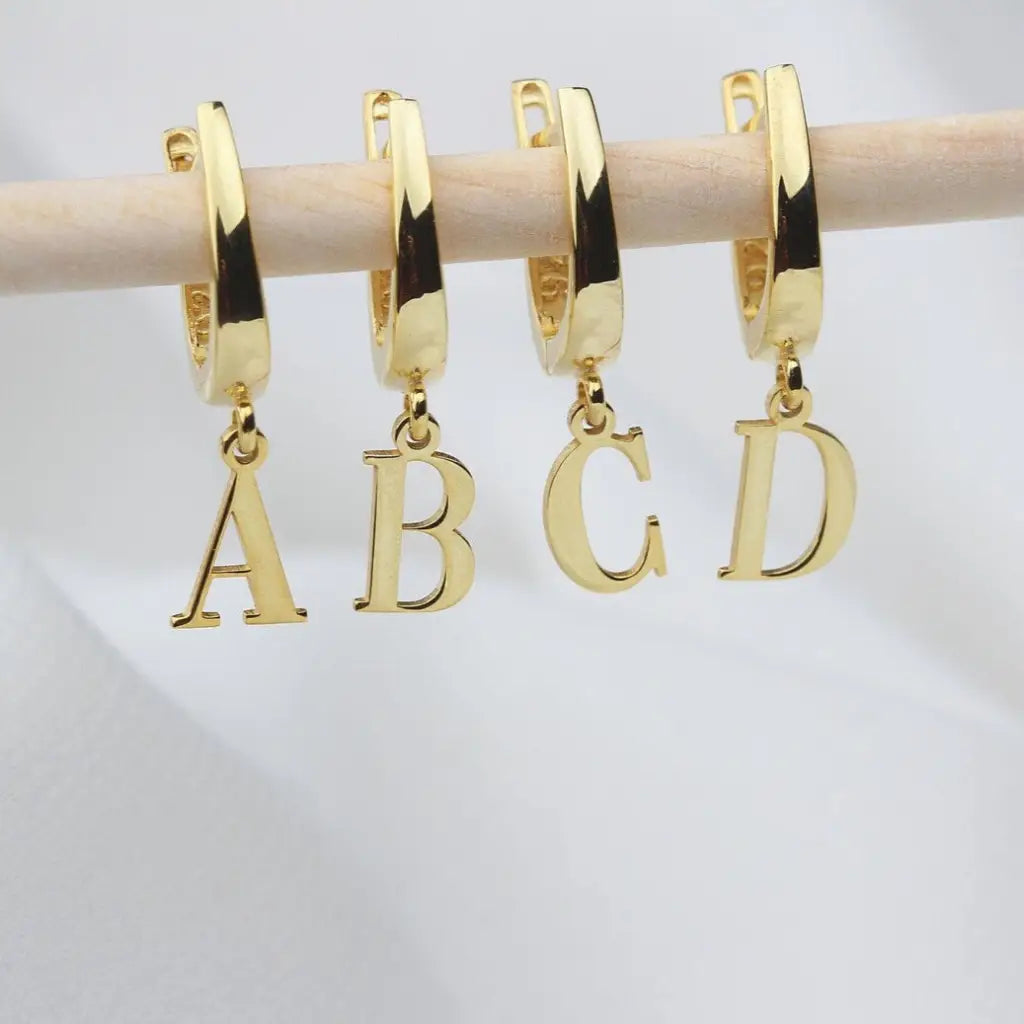 Personalized Initial Letter Hoop Earrings. Designed and handcrafted in the UAE. These gold alphabet initial earrings are locally handcrafted with the highest quality materials and artisans available in Dubai.