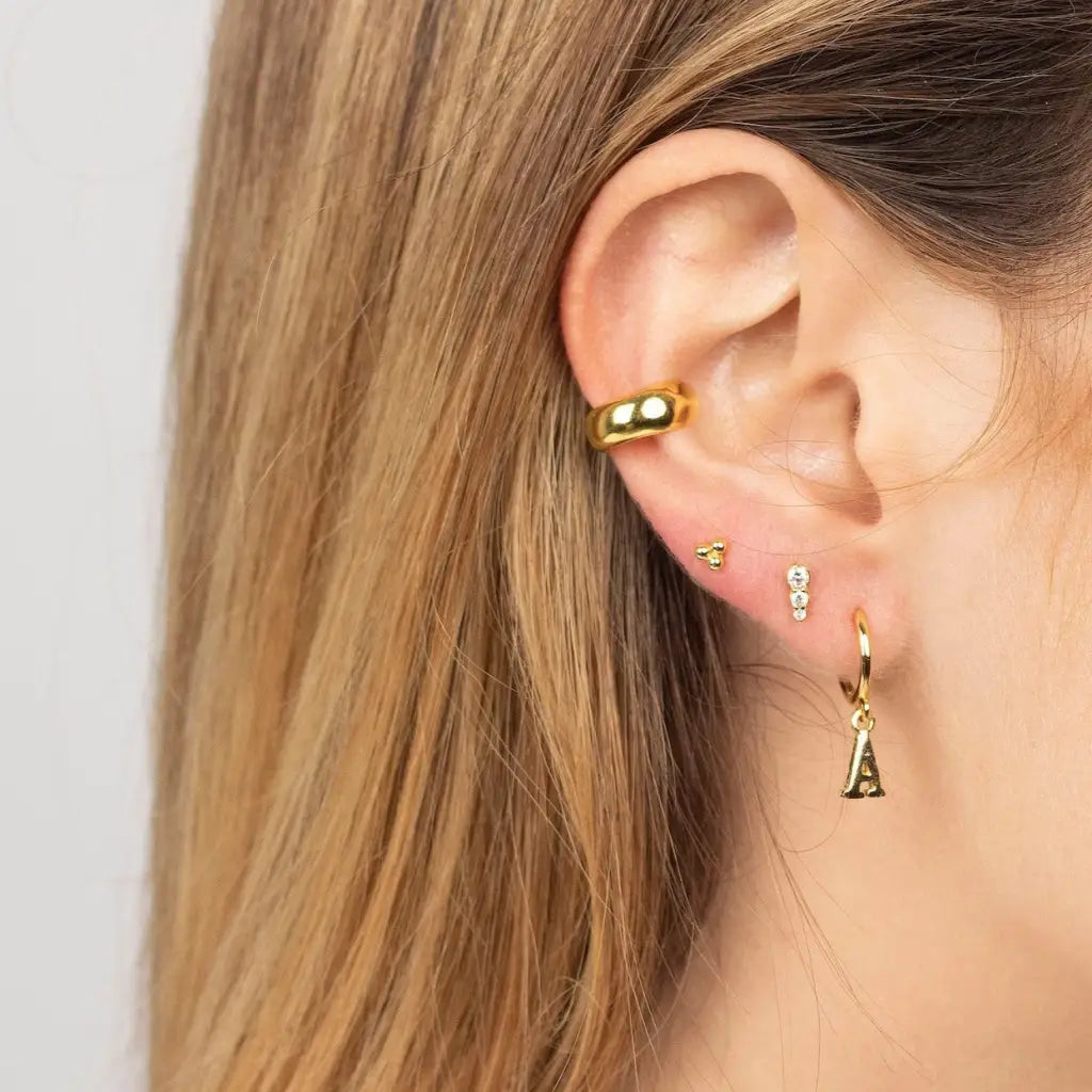 Personalized Initial Letter Hoop Earrings. Designed and handcrafted in the UAE. These gold alphabet initial earrings are locally handcrafted with the highest quality materials and artisans available in Dubai.