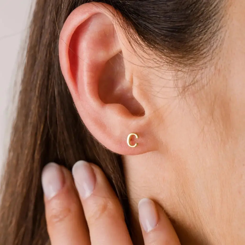 A beautiful pair of English alphabet gold initial earrings, handcrafted with a modern and minimal design that will shine radiantly and captures the eye with its charismatic brilliance. Adaptable to any style, and perfect to wear on any occasion. Beautifully handmade to the highest standards in the United Arab Emirates.
