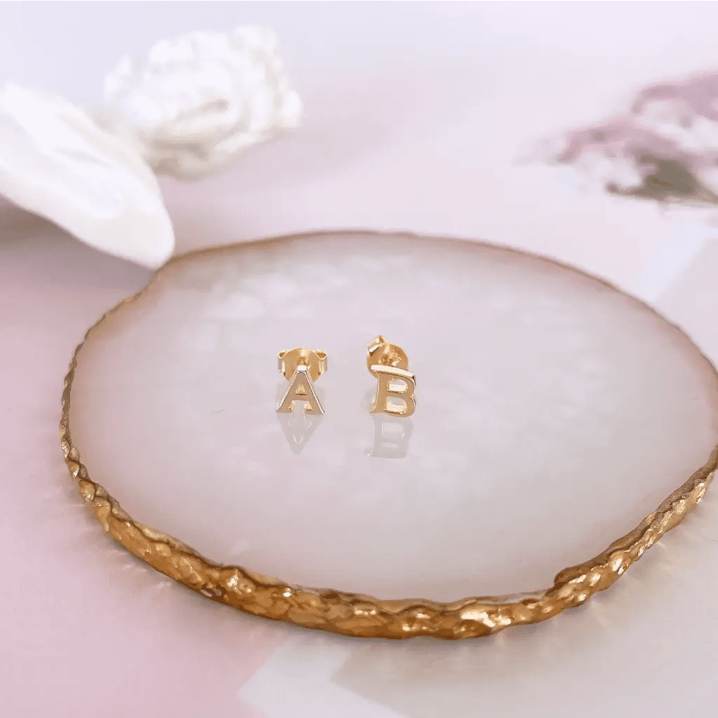 A beautiful pair of English alphabet gold initial earrings, handcrafted with a modern and minimal design that will shine radiantly and captures the eye with its charismatic brilliance. Adaptable to any style, and perfect to wear on any occasion. Beautifully handmade to the highest standards in the United Arab Emirates.