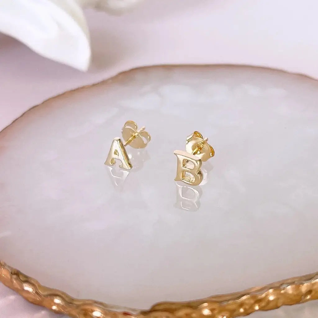 A beautiful pair of English alphabet gold initial earrings, handcrafted with a modern and minimal design that will shine radiantly and captures the eye with its charismatic brilliance. Adaptable to any style, and perfect to wear on any occasion. Beautifully handmade to the highest standards in the United Arab Emirates.