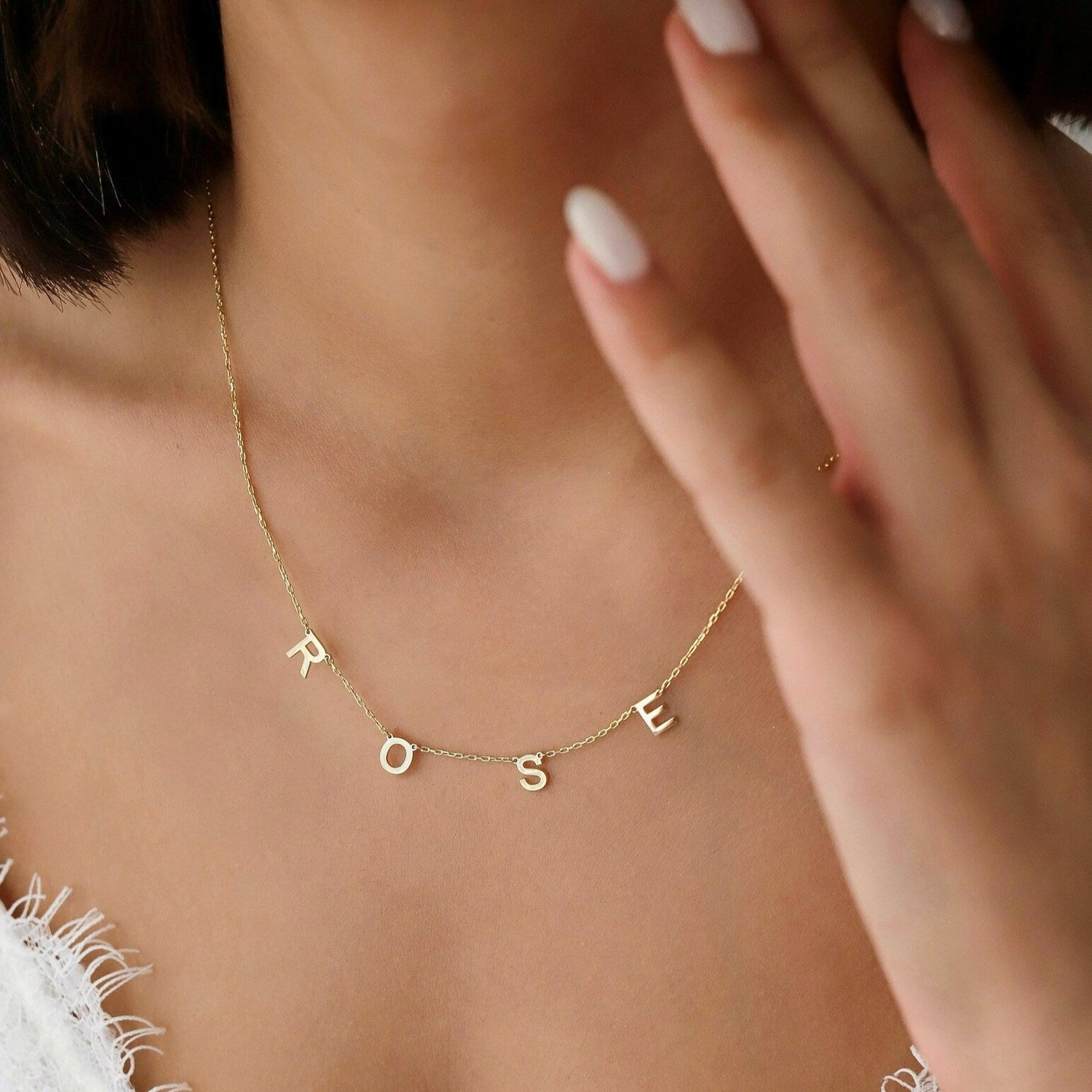 This gorgeous modern gold name necklace is handcrafted in real genuine gold by our skilled jewelers in Dubai. A truly lovely gift. Your loved one's name in gold, creating a uniquely, personal gift. Perfect addition to your jewelry collection or a gift to remember. Designed in the United Arab Emirates.