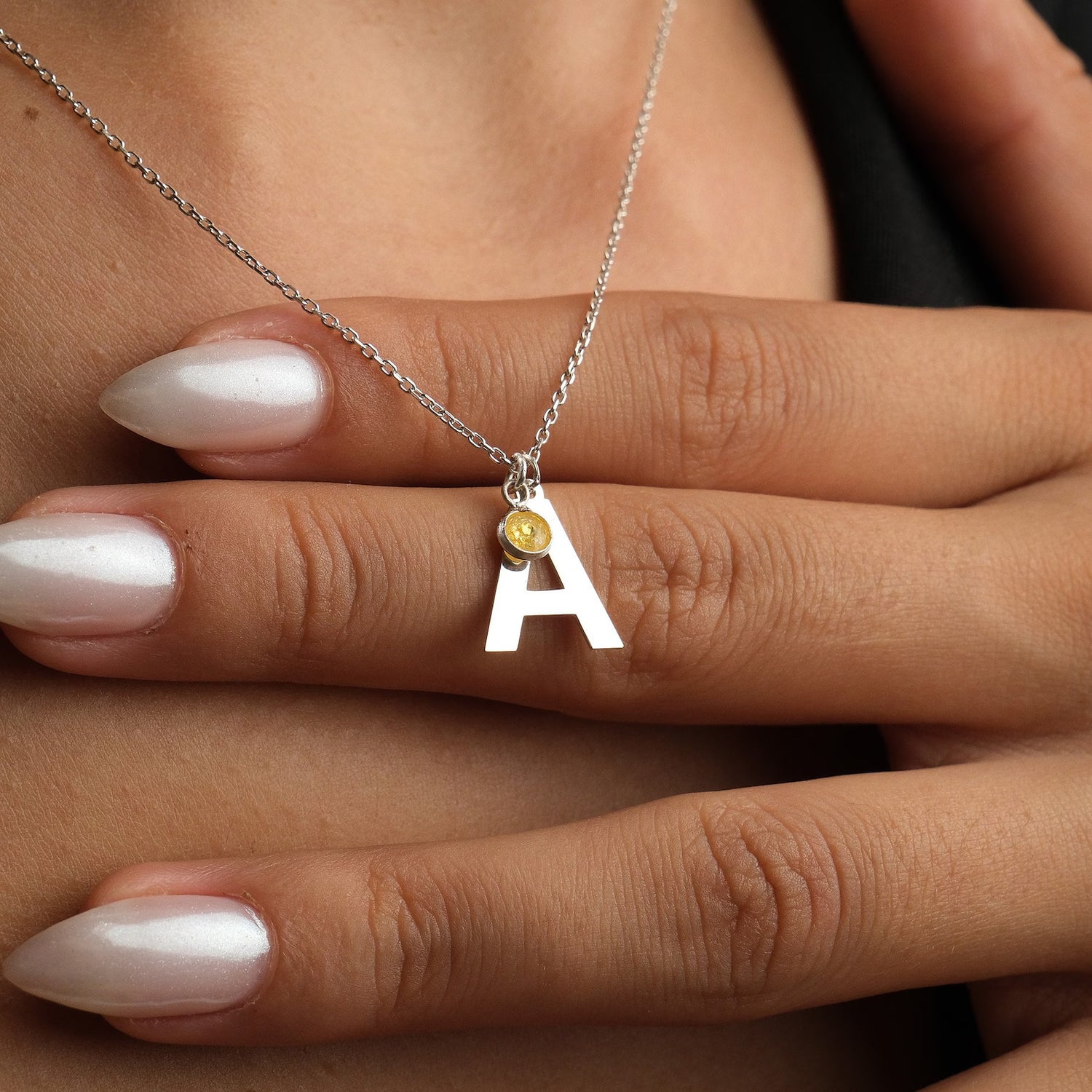 A symbol of love, this elegant 18 carat gold initial birthstone necklace features a delicate gemstone and a personalized letter pendant, making it a thoughtful present for your loved one. Whether she's your girlfriend, fiancée, wife, sister, or mother, this necklace adds a touch of sophistication and exclusivity to any outfit and is the perfect gift to show that special woman in your life how much she means to you.