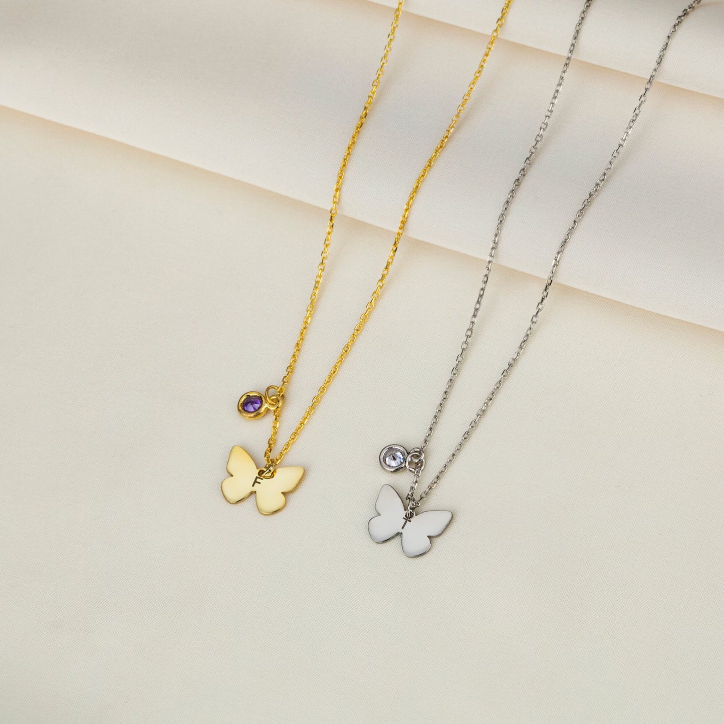 Personalized Gold Butterfly Initial Birthstone Necklace Designed and handcrafted in the UAE. Pamper your loved one with this exquisite 18 carat gold butterfly initial birthstone necklace, complete with a delicate gold butterfly, birthstone and the initial of your choice.