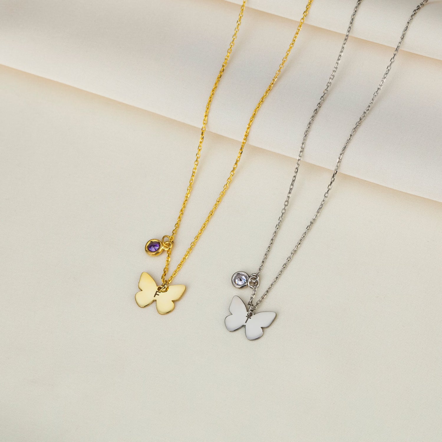 Personalized Gold Butterfly Initial Birthstone Necklace Designed and handcrafted in the UAE. Pamper your loved one with this exquisite 18 carat gold butterfly initial birthstone necklace, complete with a delicate gold butterfly, birthstone and the initial of your choice.