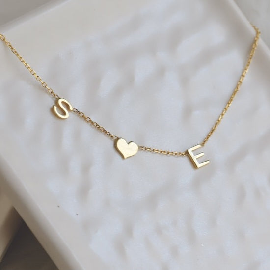 Gold Heart Letter Initial Necklace Personalized, designed and handcrafted in the UAE. Delivers within 2 to 5 business days. This fine and minimal sideways initial necklace is locally handcrafted with the highest quality materials and artisans available in Dubai.