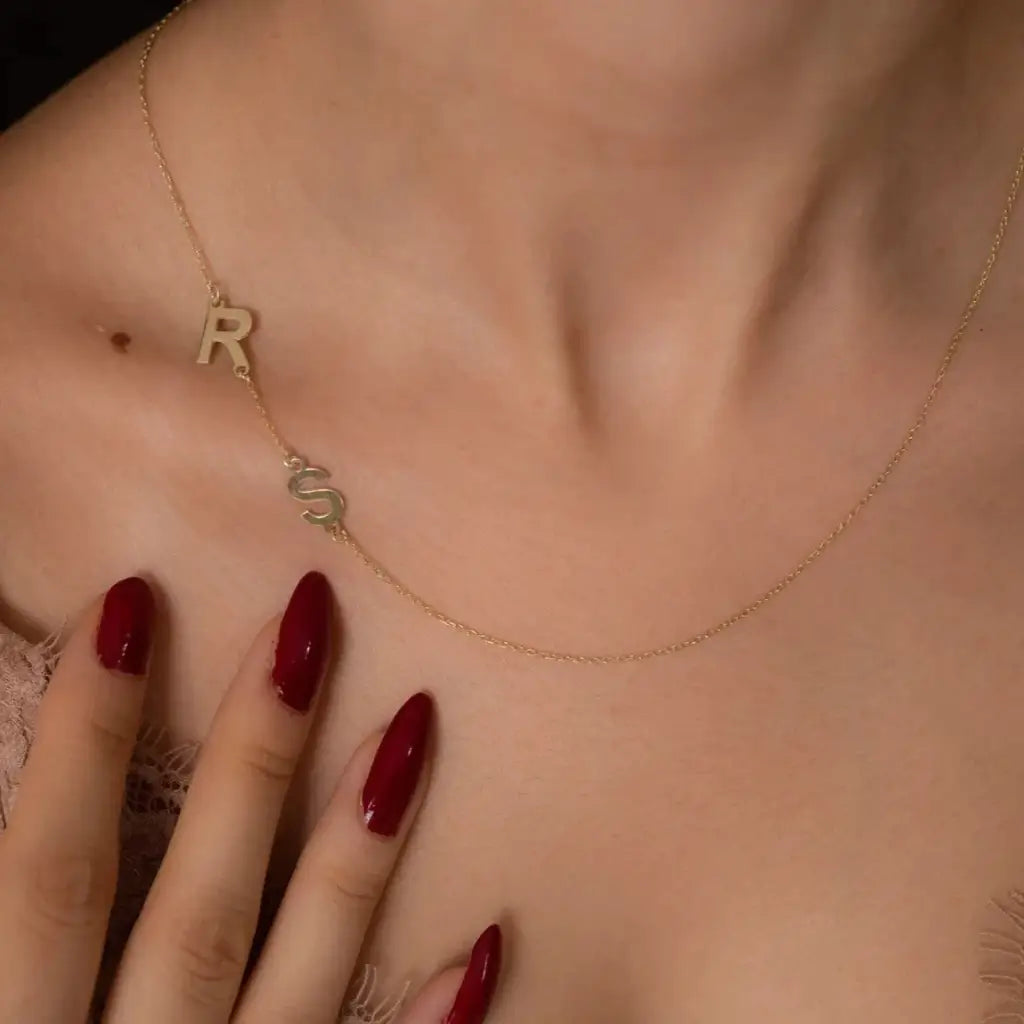Trendy and elegant, this minimal gold alphabet pendant has a playful charm. This gold necklace is attached to a fine chain made of genuine solid gold and personalized with the initials of your choice. A great addition to your jewelry collection and a thoughtful gift for the loved ones. Designed in Dubai.