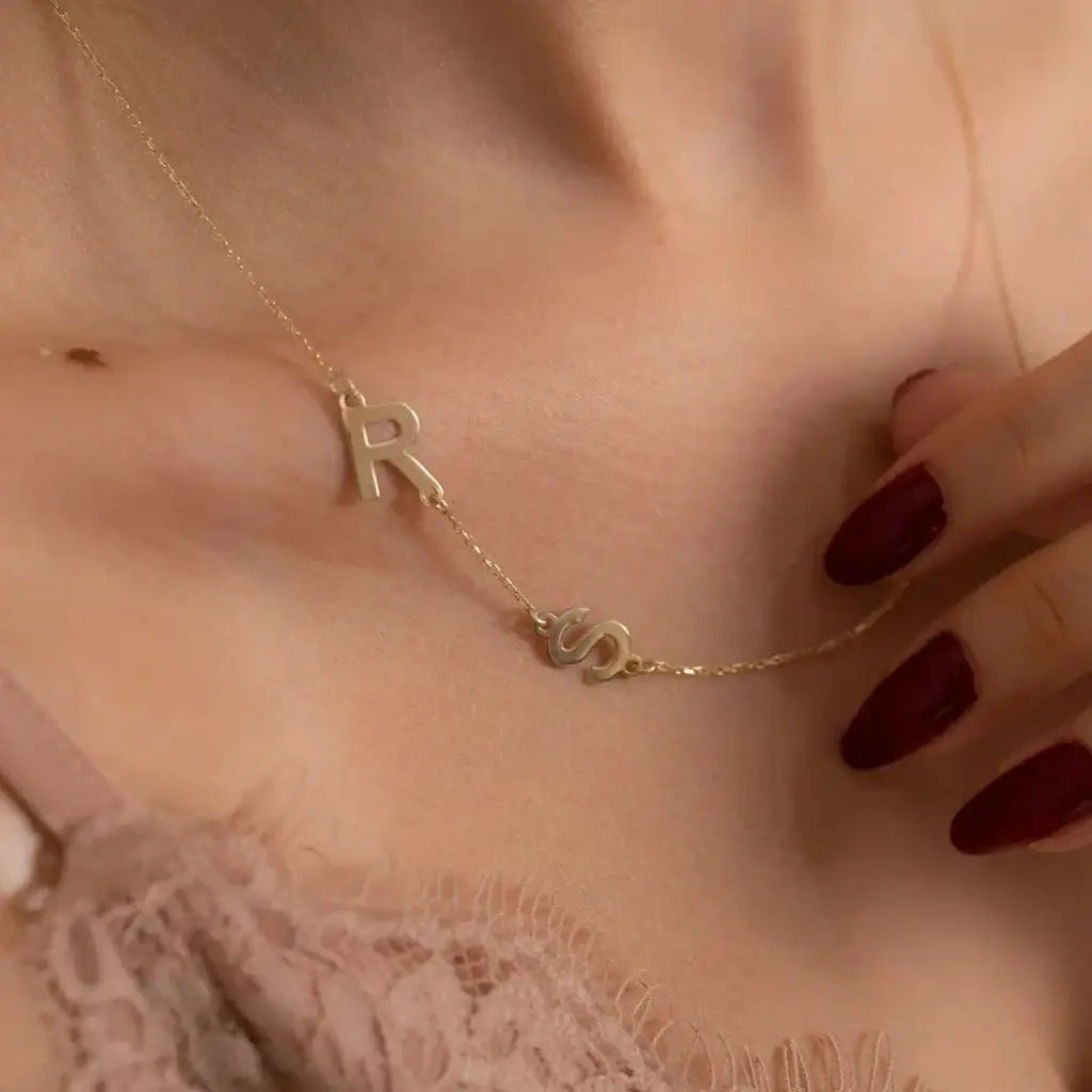 Trendy and elegant, this minimal gold alphabet pendant has a playful charm. This gold necklace is attached to a fine chain made of genuine solid gold and personalized with the initials of your choice. A great addition to your jewelry collection and a thoughtful gift for the loved ones. Designed in Dubai.