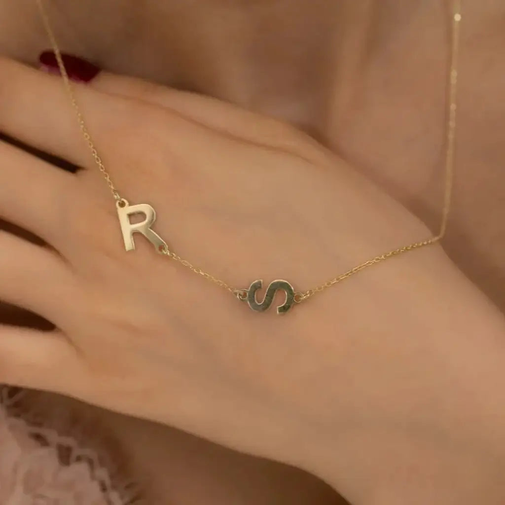 Trendy and elegant, this minimal gold alphabet pendant has a playful charm. This gold necklace is attached to a fine chain made of genuine solid gold and personalized with the initials of your choice. A great addition to your jewelry collection and a thoughtful gift for the loved ones. Designed in Dubai.