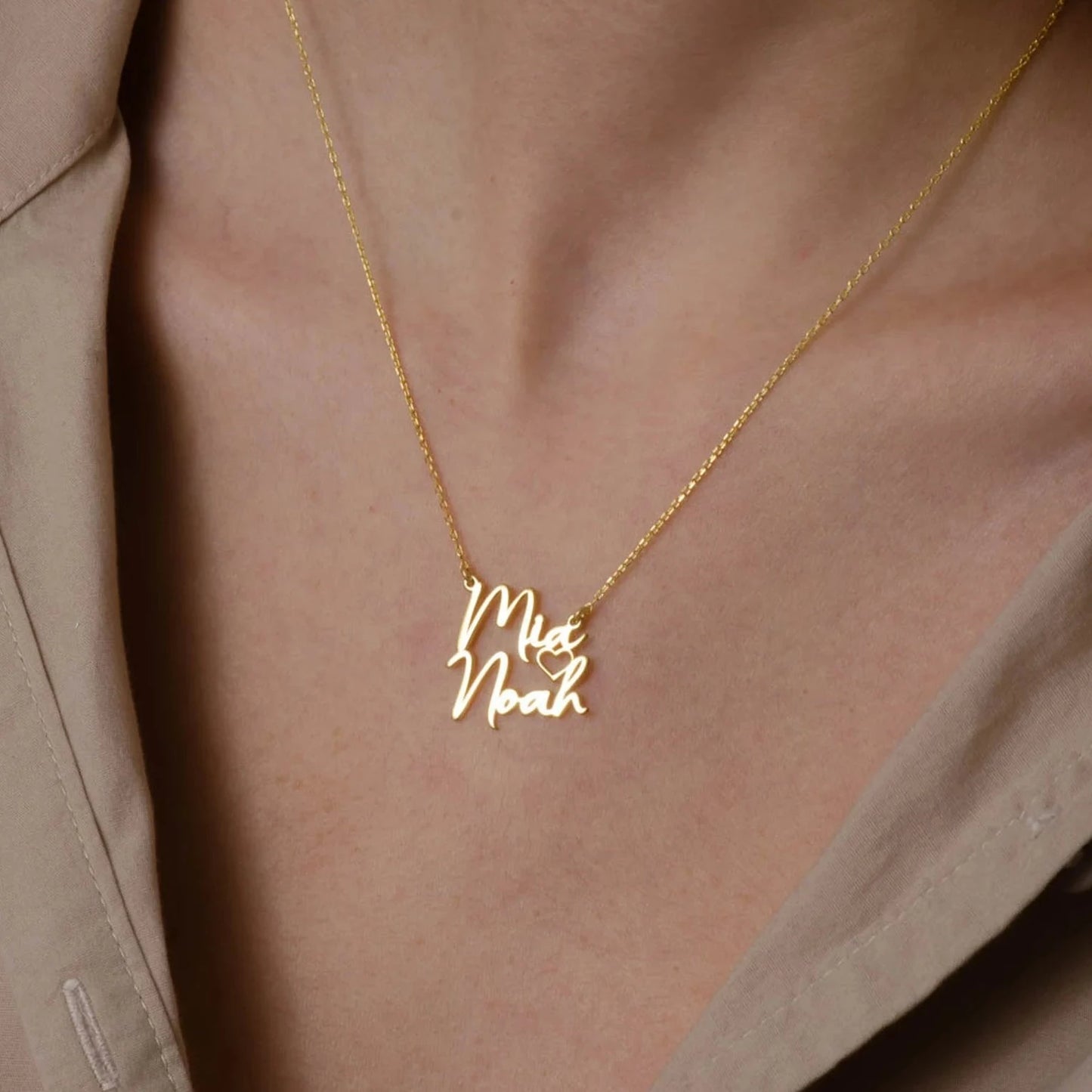 Gold Two Names Necklace - A symbol of personalized elegance by Burst of Arabia. Crafted with precision, this exquisite piece adds a touch of individuality to your style. Order now for a uniquely cherished accessory.
