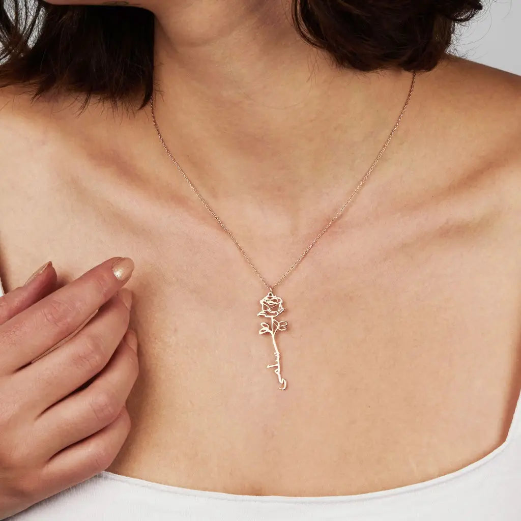 Gold Birth Flower Name Necklace made in real gold. Designed and handcrafted in the UAE. This gold birth flower Arabic name pendant is locally handcrafted with the highest quality materials and artisans available in Dubai.