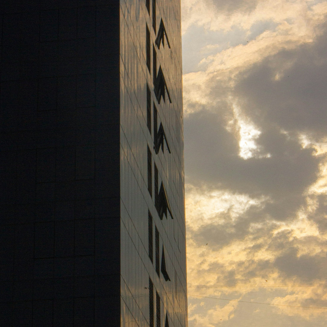 a tall building with a sky in the background