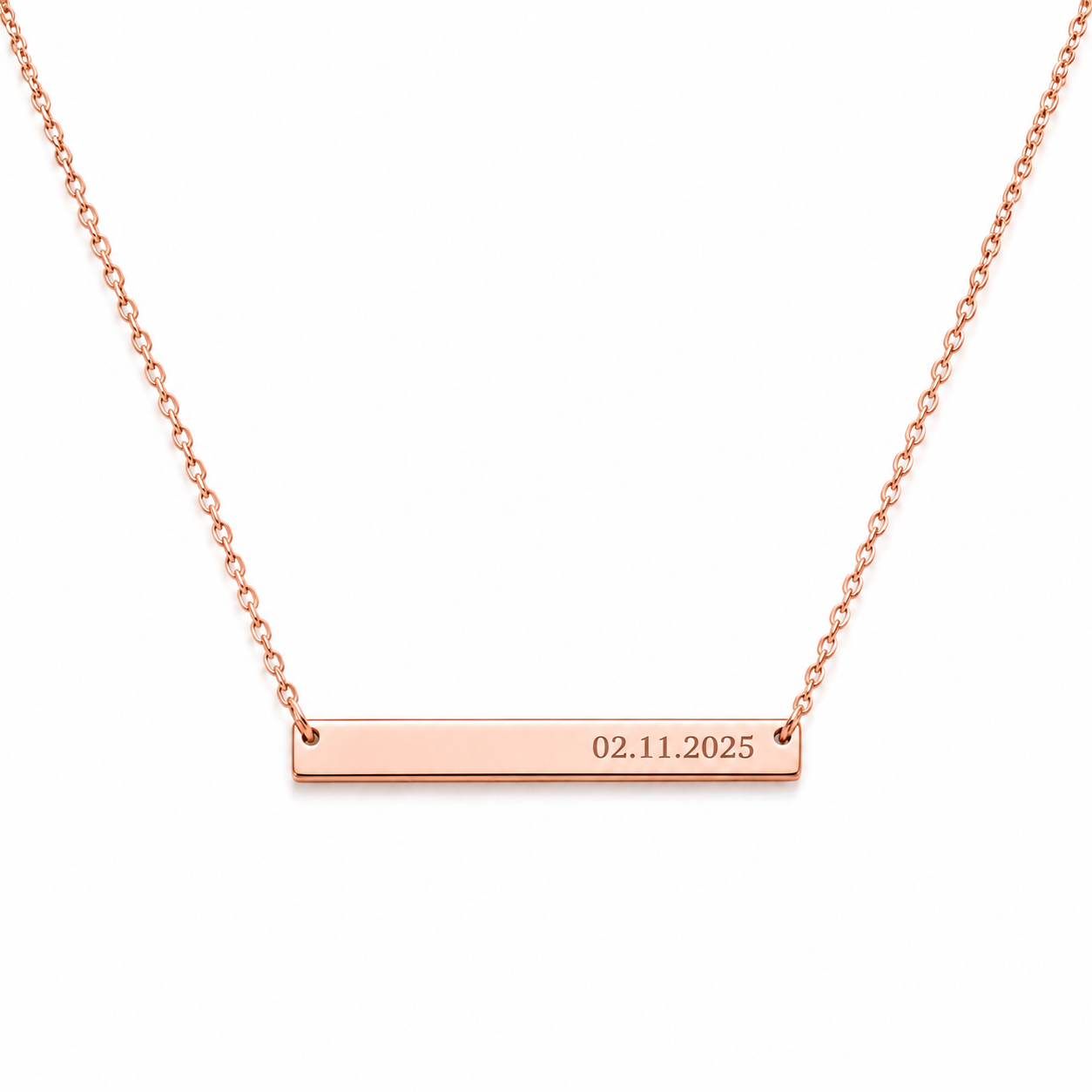 A rose gold bar necklace with a delicate chain and a horizontal bar engraved with the date '02.11.