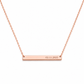 A rose gold bar necklace with a delicate chain and a horizontal bar engraved with the date '02.11.