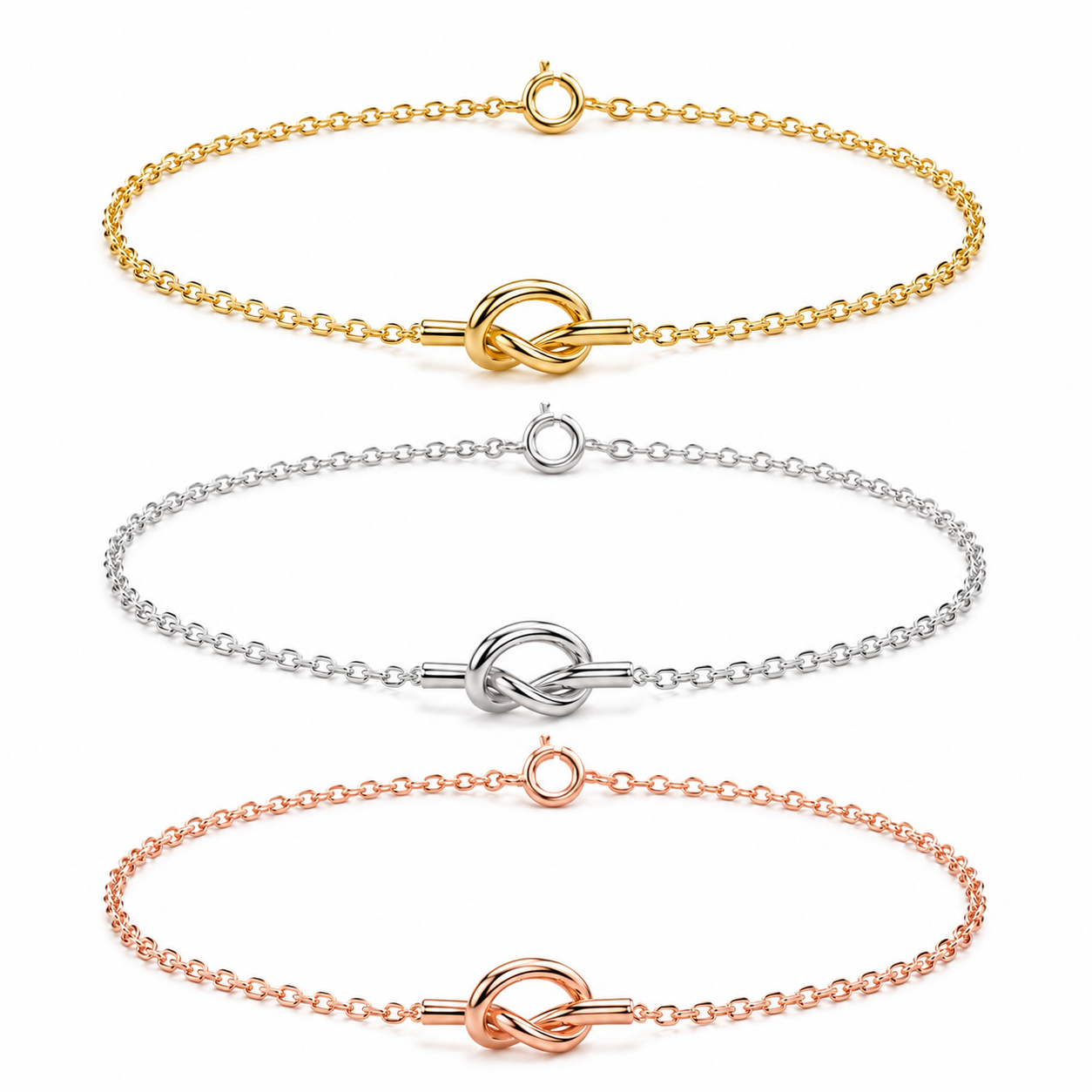Three delicate chain bracelets with a central knot-like clasp are shown on a plain white background, in gold, silver, and rose gold tones.