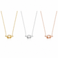 Three knot pendant necklaces on delicate chains, shown side by side in yellow gold, silver, and rose gold finishes against a plain white background.
