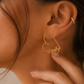 Close-up of personalised Heart-Shaped Name Earrings in solid 18K yellow gold featuring a custom name design.