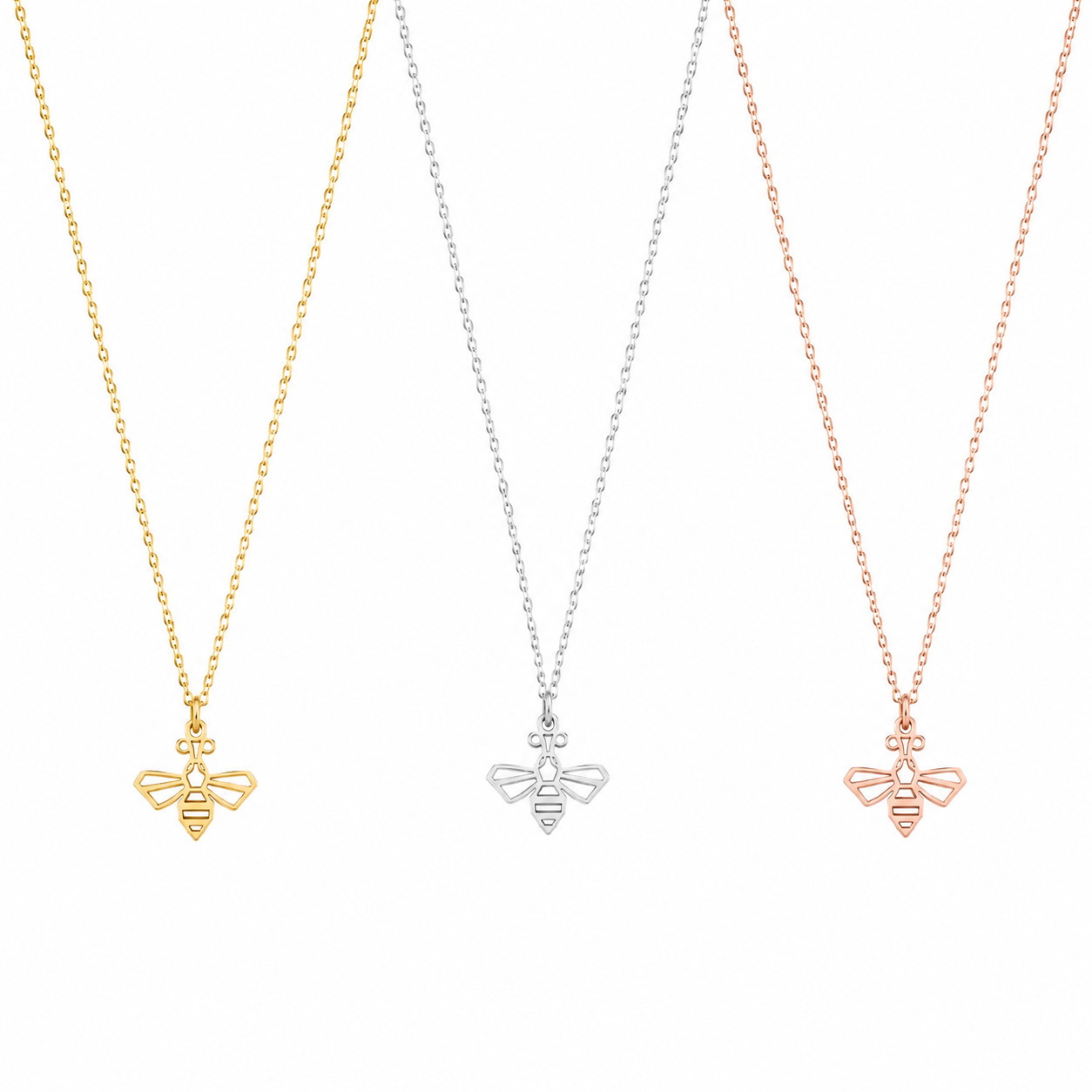 Three delicate necklace chains with small bee-shaped pendants in yellow gold, silver, and rose gold, displayed against a plain white background.