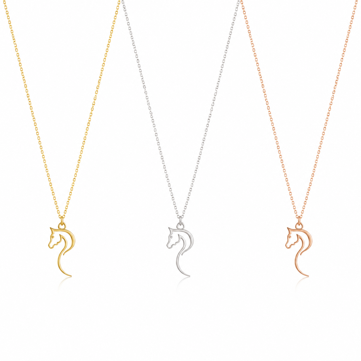 Three horse-shaped pendant necklaces on delicate chains, shown in gold, white, and rose gold finishes against a clean white background.