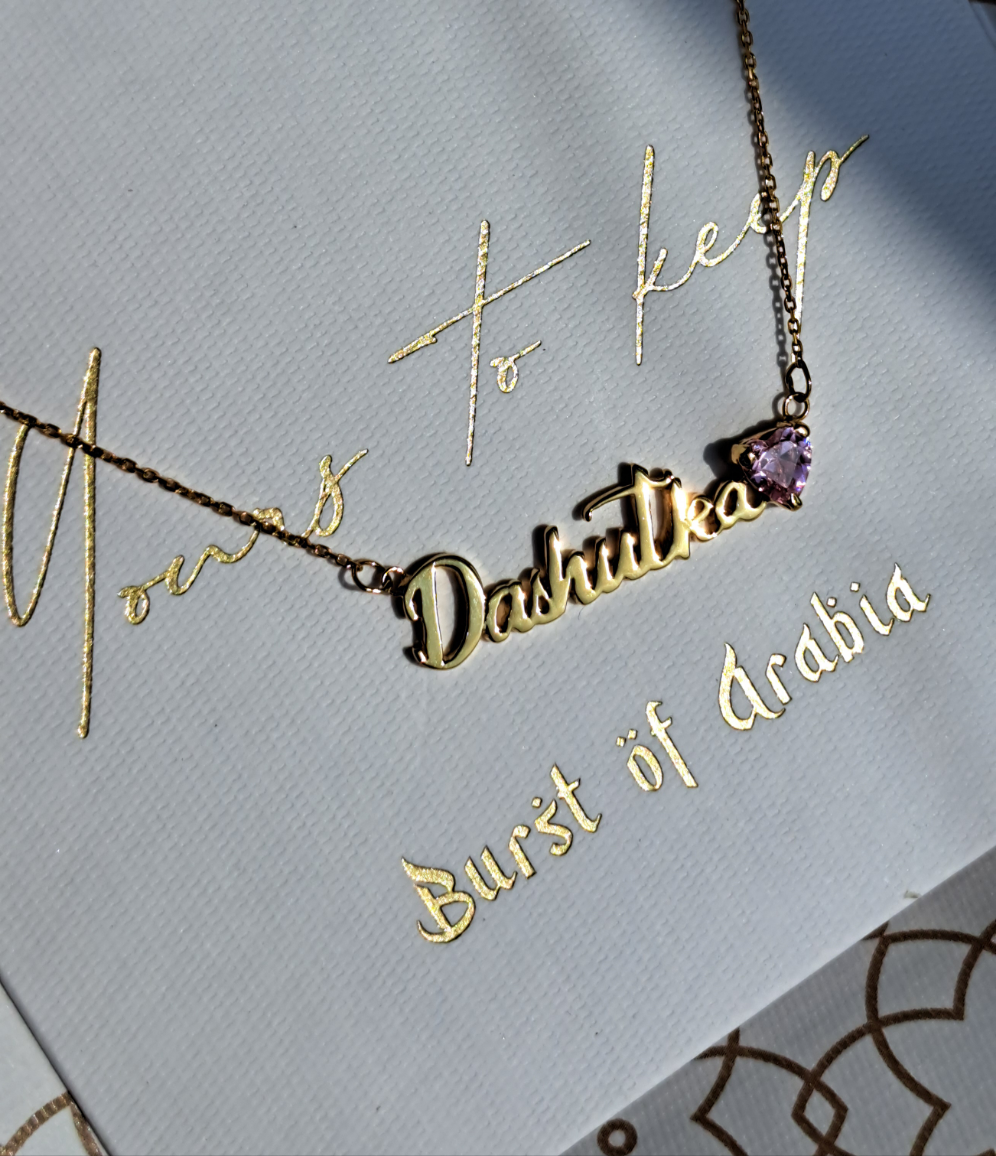 Handmade 18K gold name heart-shaped name birthstone necklace in Dubai, available in yellow, rose, and white gold, with shipping to all UAE emirates, GCC, UK, and USA.