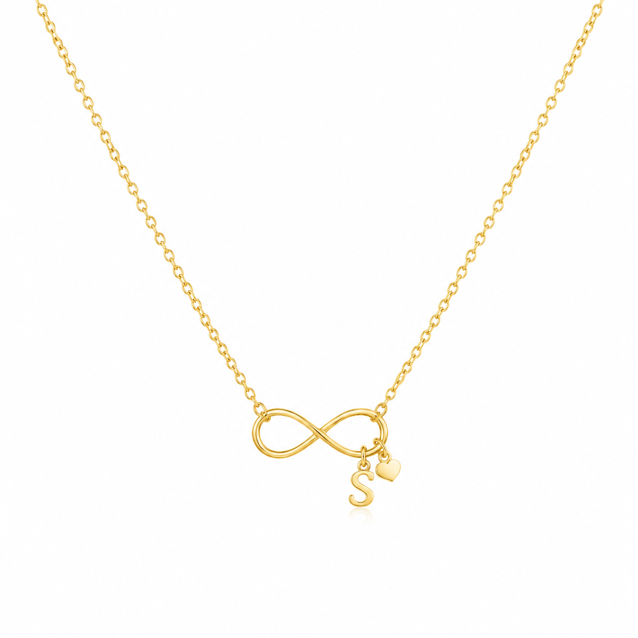 A delicate gold chain necklace featuring an infinity symbol pendant with a small hanging initial 'S' charm and a tiny heart, shown on a plain white background.