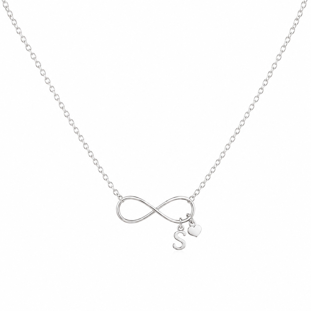 A whitr gold chain necklace featuring an infinity symbol pendant with a small hanging initial 'S' charm and a tiny heart charm, shown on a plain white background.