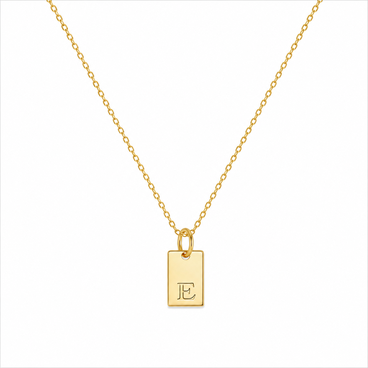 A delicate gold chain necklace with a small rectangular gold pendant engraved with the initials 'JE', shown on a plain white background.