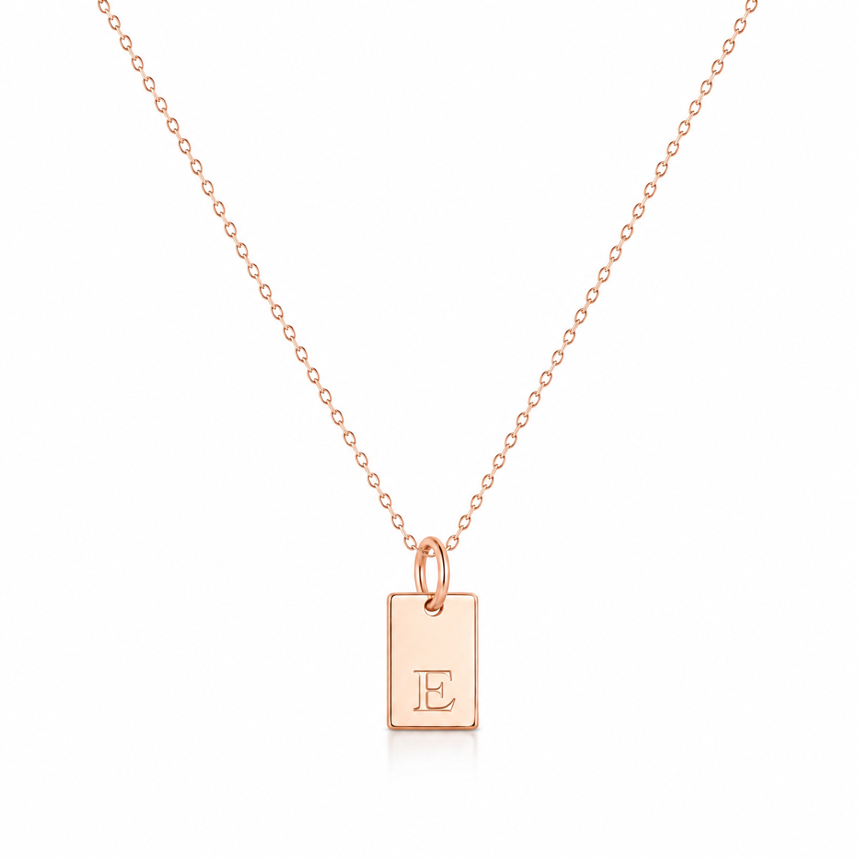A delicate rose gold chain necklace with a small rectangular pendant engraved with the letter 'E', displayed on a clean white background.