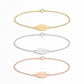 Three personalized chain bracelets with oval initial plates engraved with 'BsM', shown in gold, silver, and rose gold tones on a clean white background.
