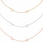 Three delicate necklace chains are shown on a white background, each featuring a small openwork letter M and a small openwork heart in different metal finishes: gold, silver, and rose gold.