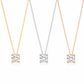 Three solitaire diamond pendant necklaces on delicate chains, shown in yellow gold, silver, and rose gold tones against a clean white background.
